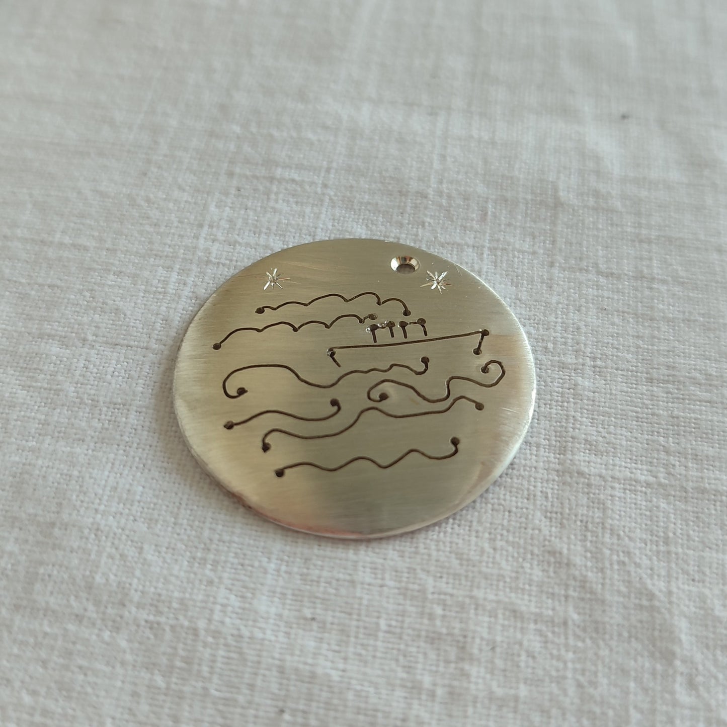 Part of a silver ring representing a steamship