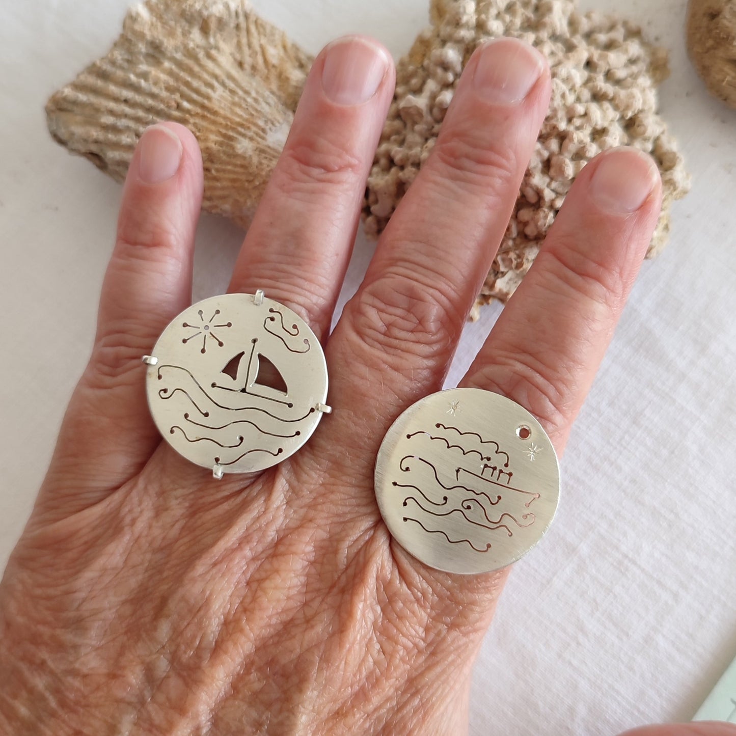 Two silver rings on a hand