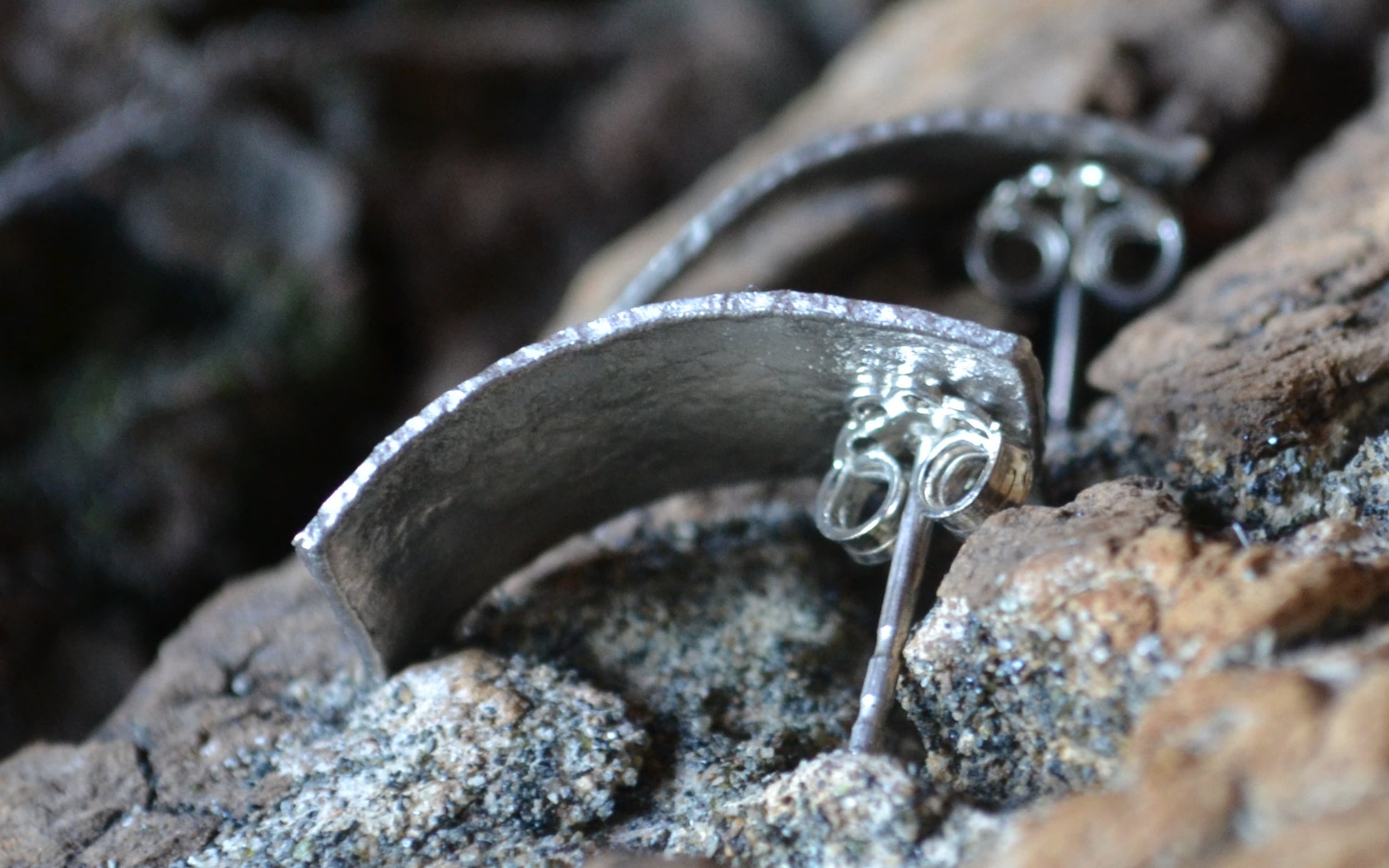 Close up of handmade rectangula silver earrings