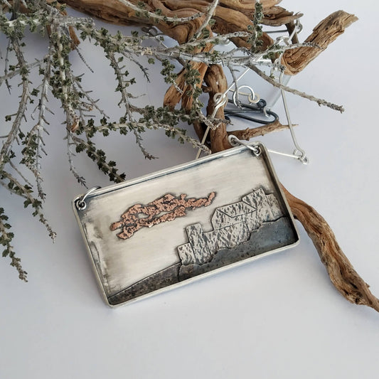 Silver pendant with oxidized silver and copper layers representing a village in Italy